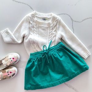 Green skirt and cream sweater